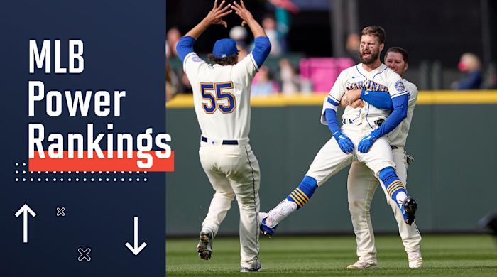 Seattle Mariners’ Jesse Winker, front right, is lifted by Ty France as he celebrates a win over Kansas City Royals in 12 innings of a baseball game, Sunday, April 24, 2022, in Seattle.